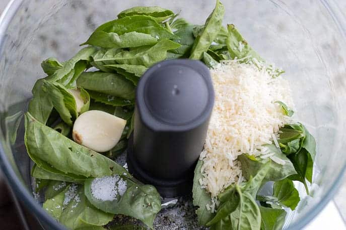 Food processor with fresh basil, garlic, parmesan cheese and black pepper