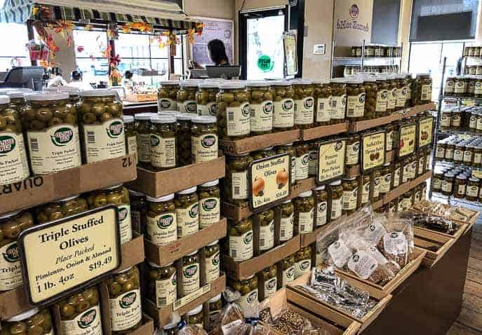 Inside the Olive Pit store and cafe, shelves of olive jars
