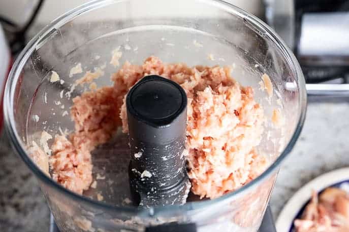 Raw chicken processed in a food processor