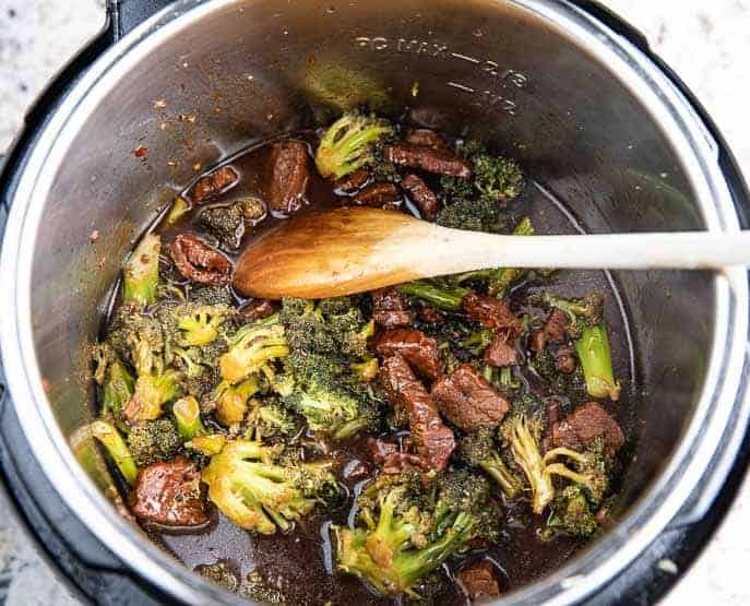 Mongolian Beef and Broccoli in Instant Pot with wooden spoon