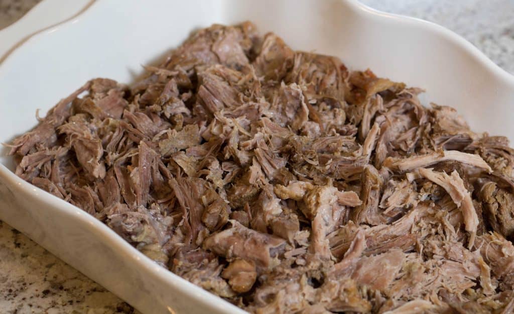 Kalua Pig shredded in white casserole dish