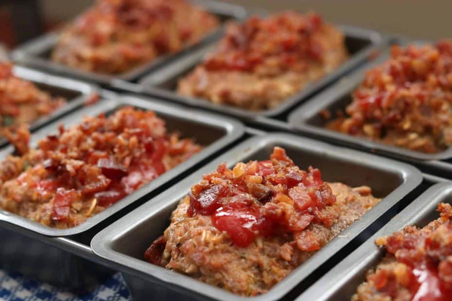 Meatloaf with ketchup and bacon crumbles in mini loaf pans