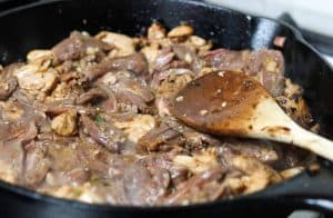 Pineapple Fajitas - cooking chicken and beef in cast iron skillet