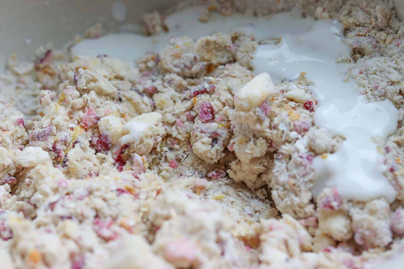 https://gourmetdoneskinny.com/wp-content/uploads/2018/11/Cranberry-Orange-Scones-adding-last-of-buttermilk.jpg