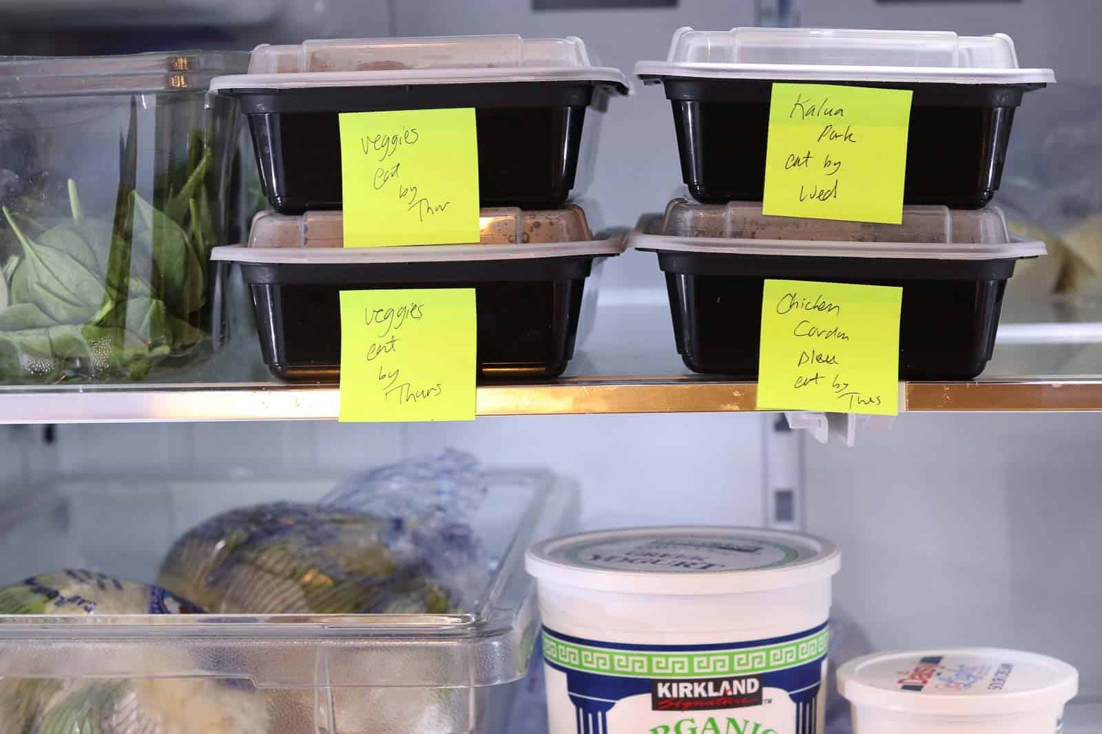 refrigerator with black boxes of food labeled veggies, pork, chicken cordon bleu, yogurt, cauliflower, sour cream from Gourmet Done Skinny