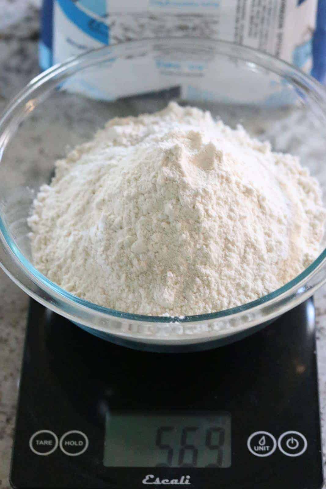 00 Caputo flour in a glass bowl on a scale.