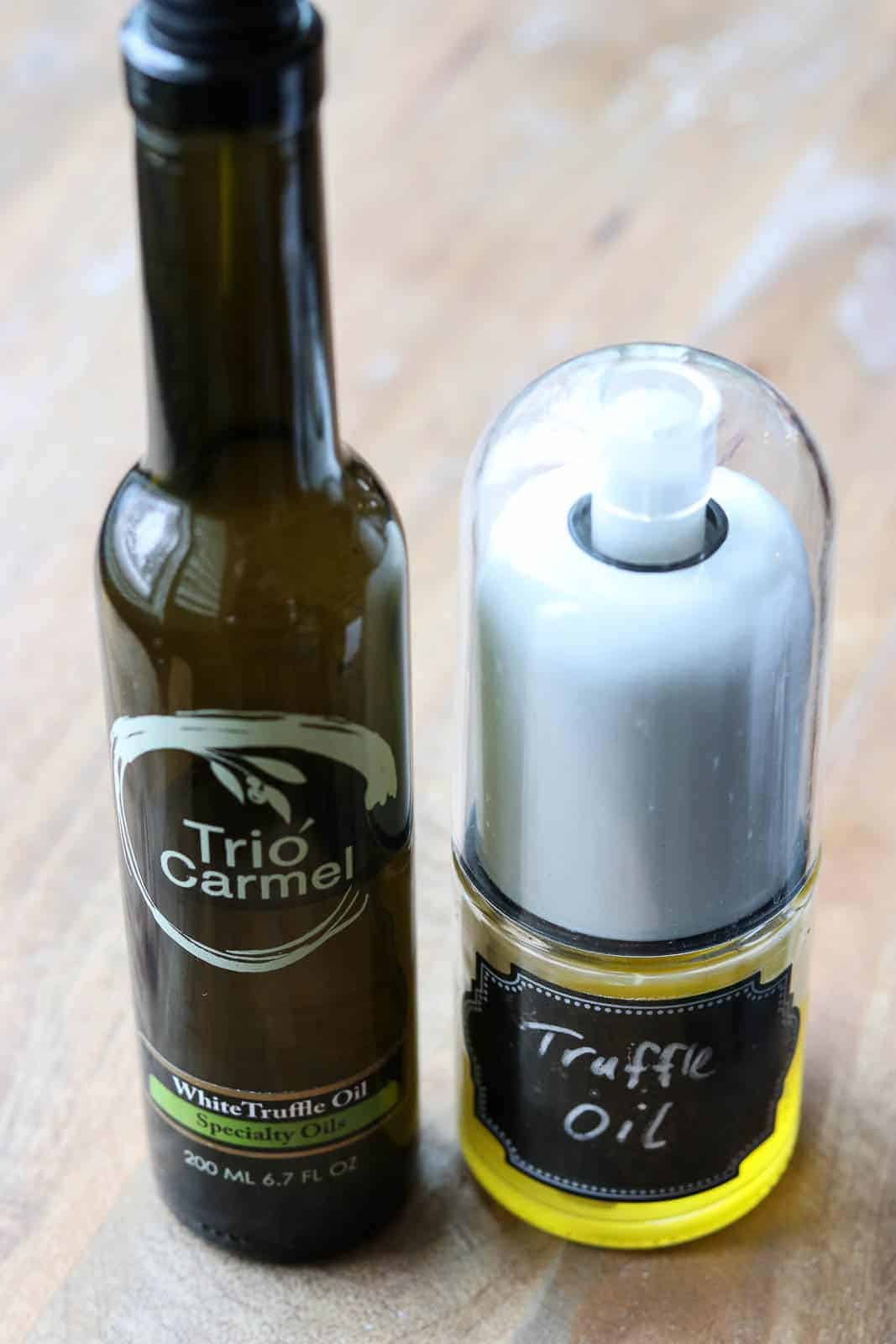 Trio White Truffle Oil Bottle next to an Olive Oil Mister with Truffle Oil from Gourmet Done Skinny