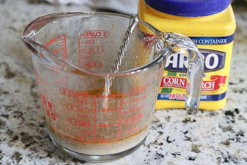 Liquid measuring cup with corn starch and beef liquid, corn starch container on granite counter from Gourmet Done Skinny