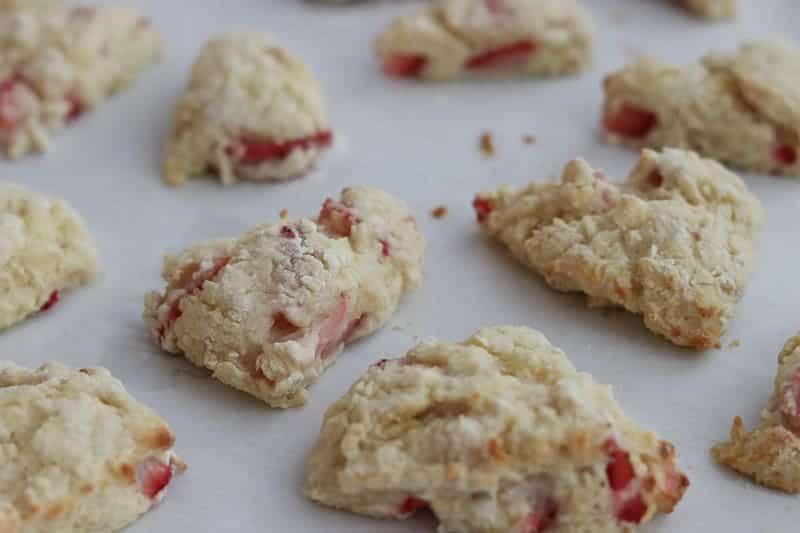 Freshly baked mini strawberry lemon scones on a baking sheet lined with parchment paper from Gourmet Done Skinny