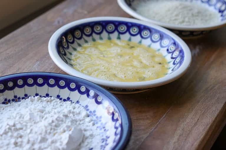 3 Polish pottery bowls with flour, egg, and panko on a wooden board from Gourmet Done Skinny