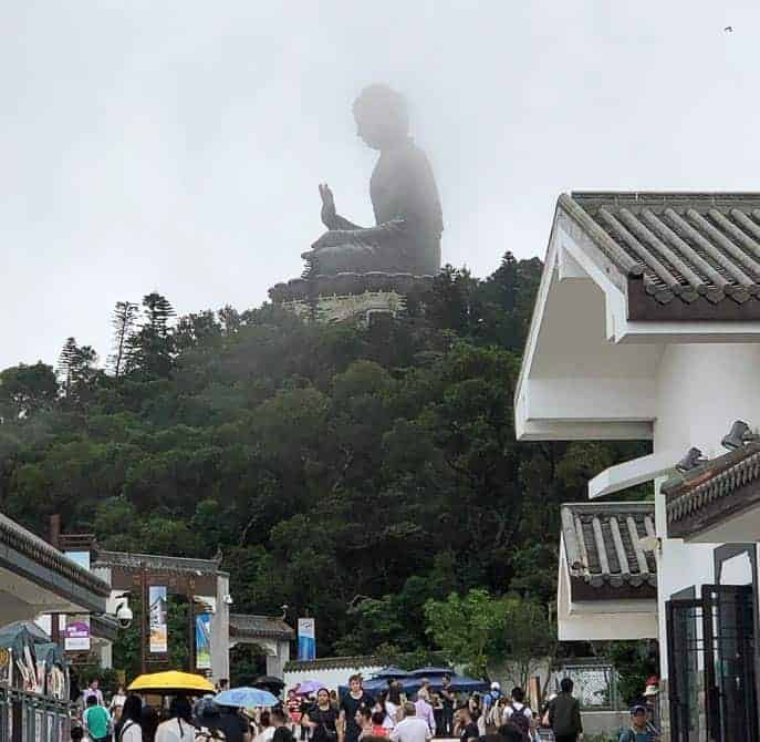 Big buddha on top of mountain with village down below