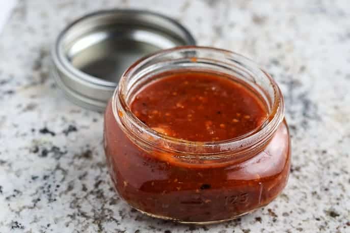 Tomato Bacon Jam on a granite counter in a Ball jar with the lid off from Gourmet Done Skinny