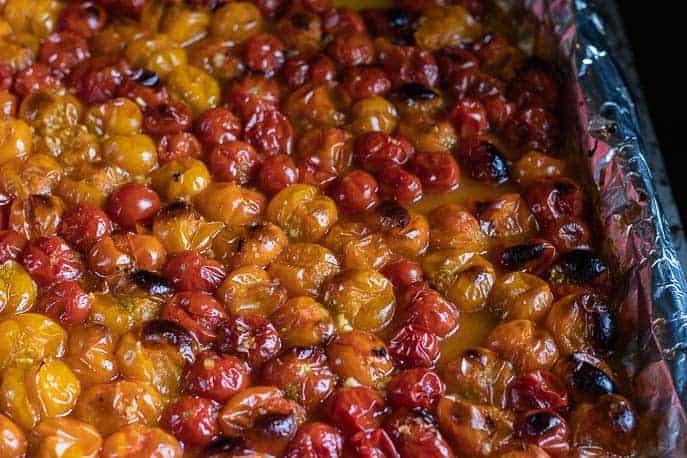 Quick and Easy Roasted Cherry Tomatoes-tomatoes roasted on a foil lined baking sheet from Gourmet Done Skinny