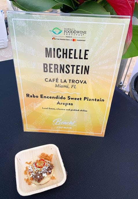 Sign with Chef name Michelle Bernstein and her Rabo Encendido Sweet Plantain Arepas dish