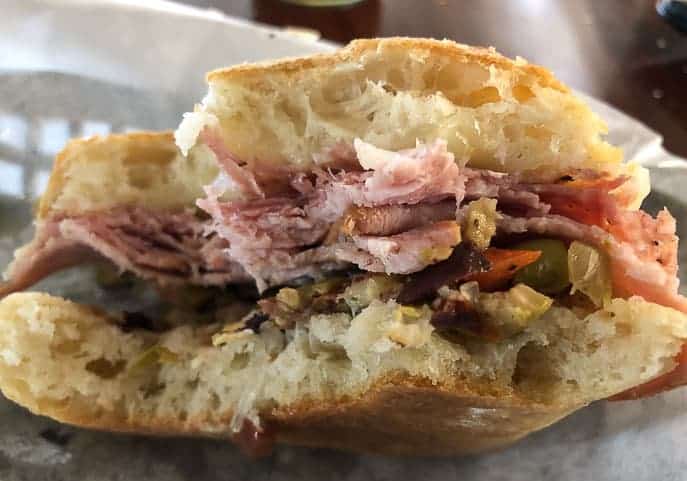 Muffaletta Sandwich with bites taken out.
