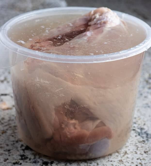 Large container with brine and turkey
