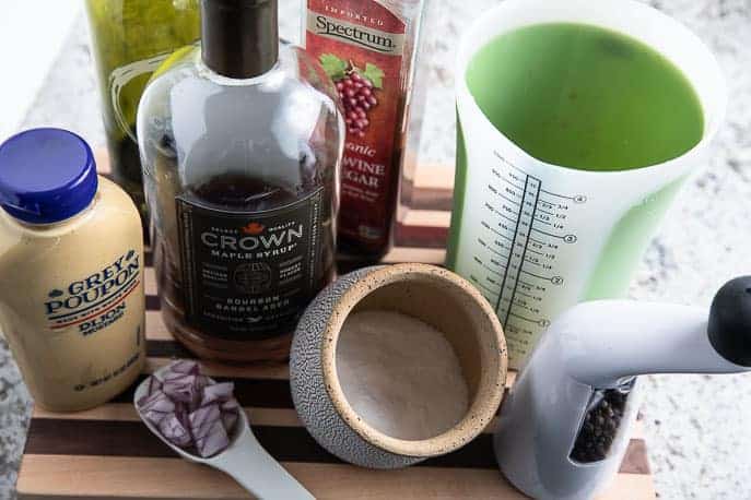 Ingredients for the Maple Dijon Vinaigrette on a wooden board