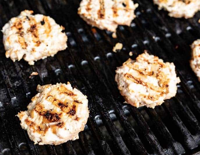 Chicken burgers on a grill