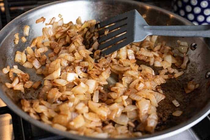 Caramelized onions in a pan with a spatula