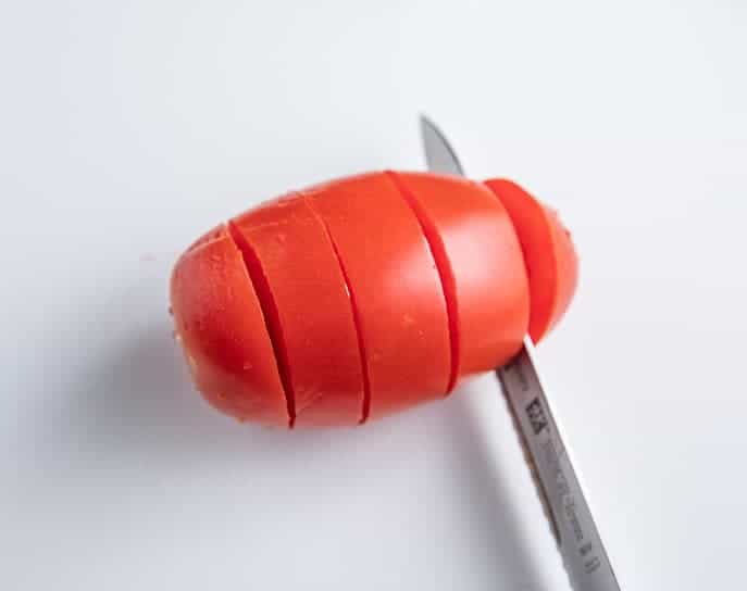 roma tomato sliced with knife