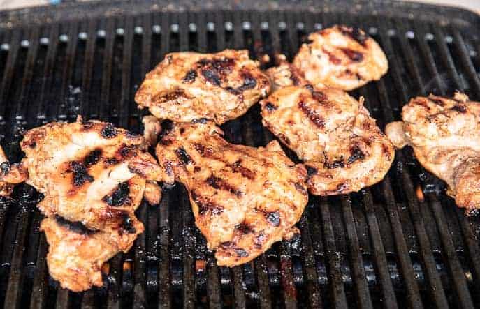 chicken thighs on a grill