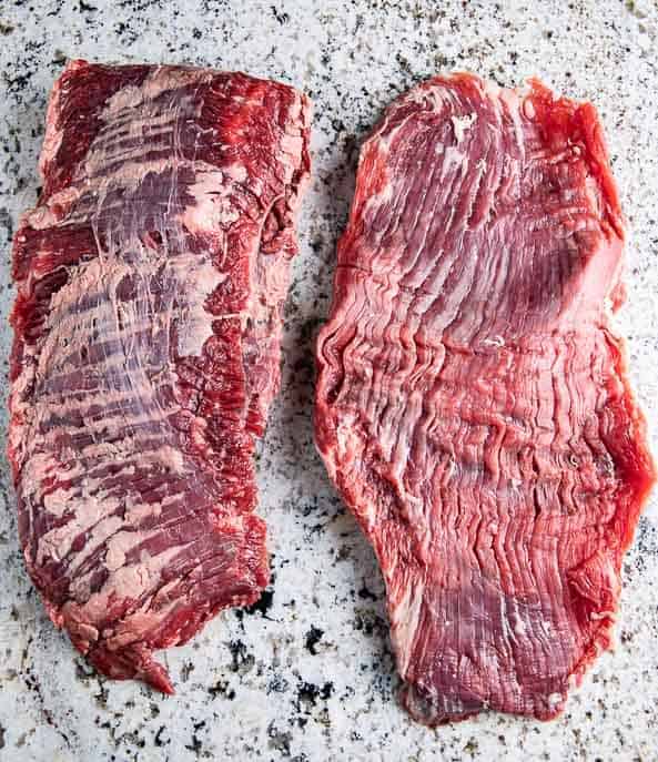 Side by side - Skirt steak and flank steak on a granite counter top