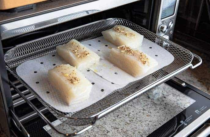 halibut on perforated parchment liner in Breville Smart Oven Air oven