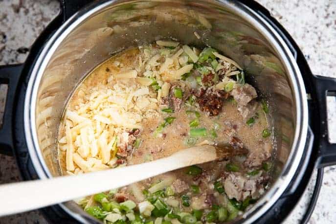 Instant POt with cheese, chicken, bacon, green onions and wooden spoon