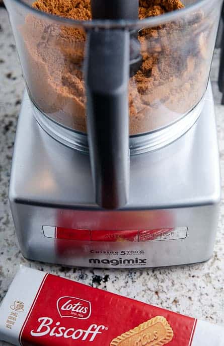 Magimix food processor with crushed cookies, package of Biscoff cookies on the countertop