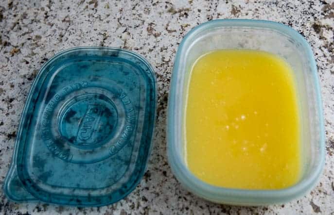 lime curd in a blue plastic container with lid