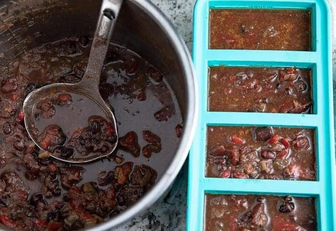 Healthy Soup Recipes: Instant Pot with Caribbean Black Bean Soup; souper cubes next to pot filled with the same soup.