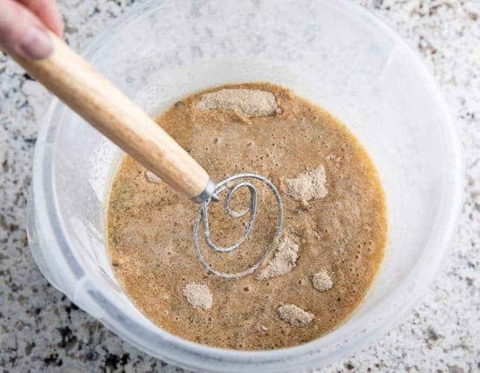 danish whisk mixing flour mixture in bucket