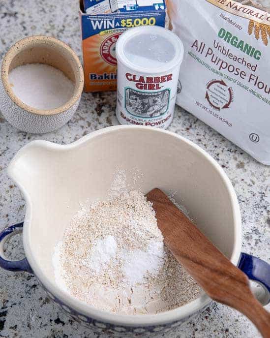 oatmeal flour mixture in a bowl, baking powder and soda, flour, salt on a granite counter top