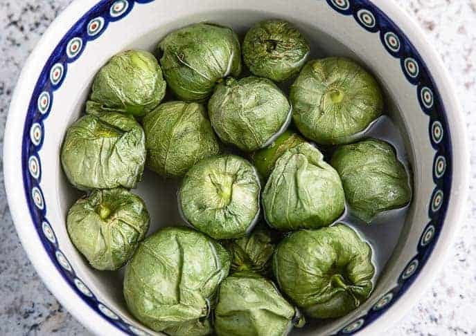 tomatillos in water in a Polish pottery bowl