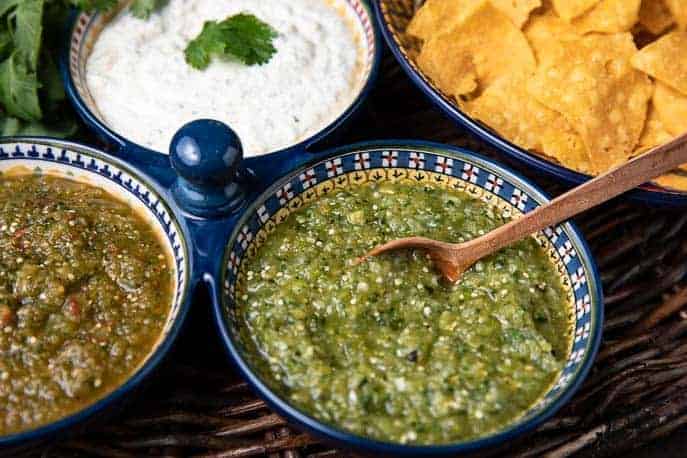 green and red tomatillo salsa, Chipotle Cilantro dressing all in a dish, tortilla chips on side