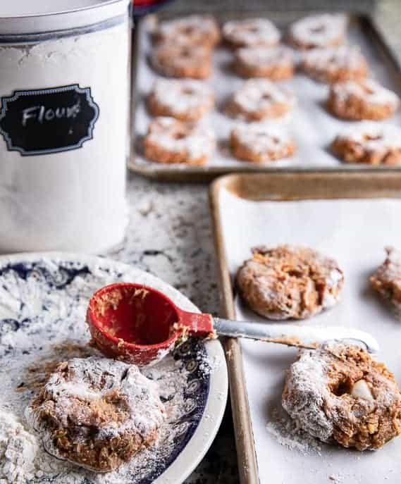 turkey slider on a plate with measuring cup; turkey sliders on baking sheets, flour container