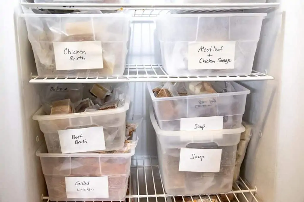 freezer with labeled boxes of food