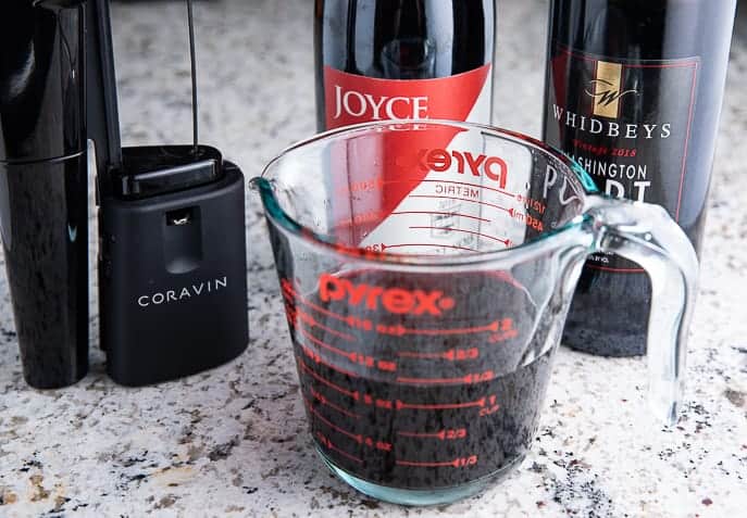 measuring cup with wine and port, coravin and 2 bottles -wine and port