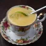 Lime Curd in a tea cup with a spoon and lime slice