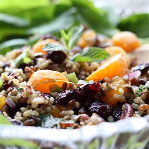 Mandarin Wild rice salad in a glass bowl with spoon