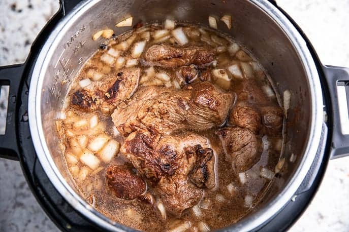 pork, onions, broth, marinade in Instant Pot