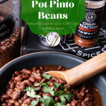 Spicy Instant Pot PInto Beans with wooden spoon and spices in black bowl