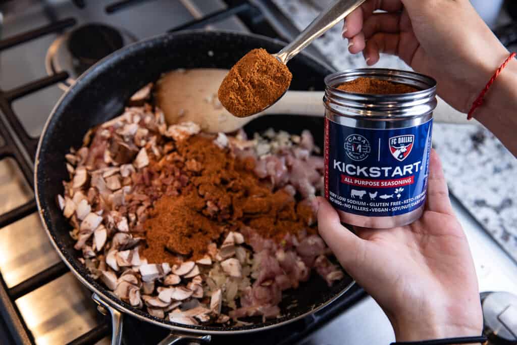 Kickstart seasoning and mushrooms, onions in a pan