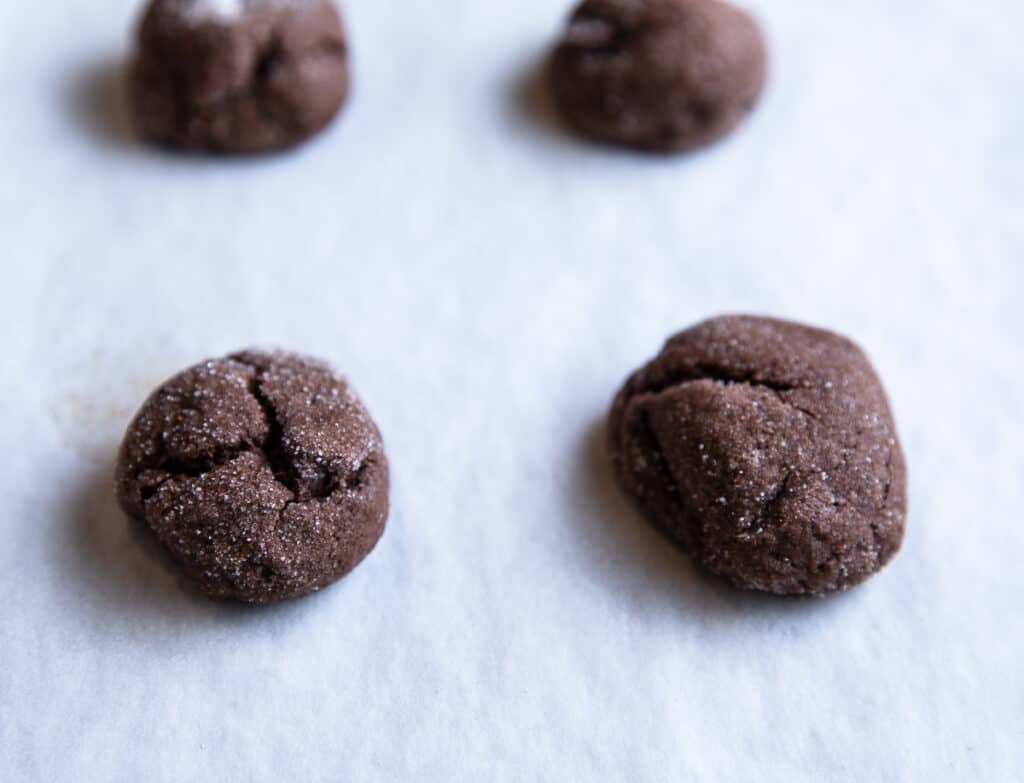 chocolate drops on a cookie sheet with parchment