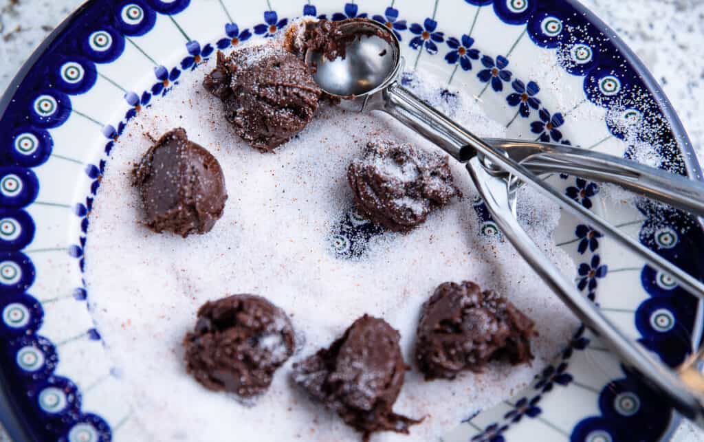 sugar in a bowl with chocolate dough and scoop