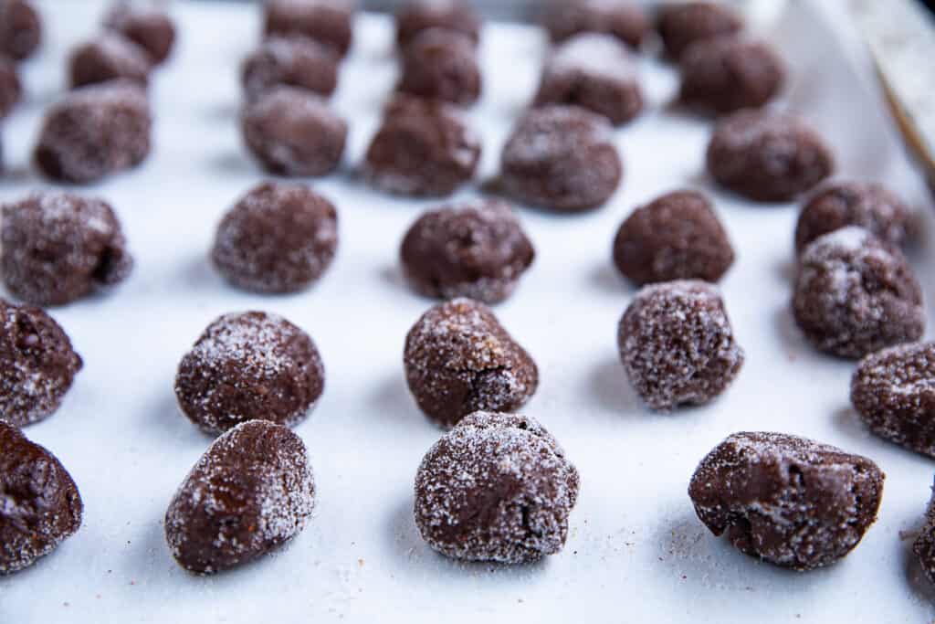 chocolate drops on a baking sheet with parchment