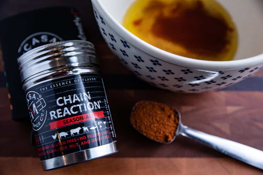 Chain Reaction spice, bowl with butter and tabasco, tablespoon of spiceo