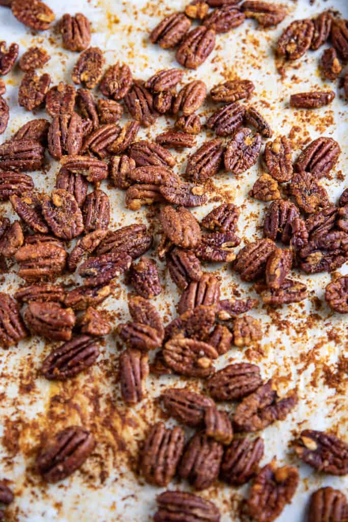 roasted spicy holiday pecans on parchment paper