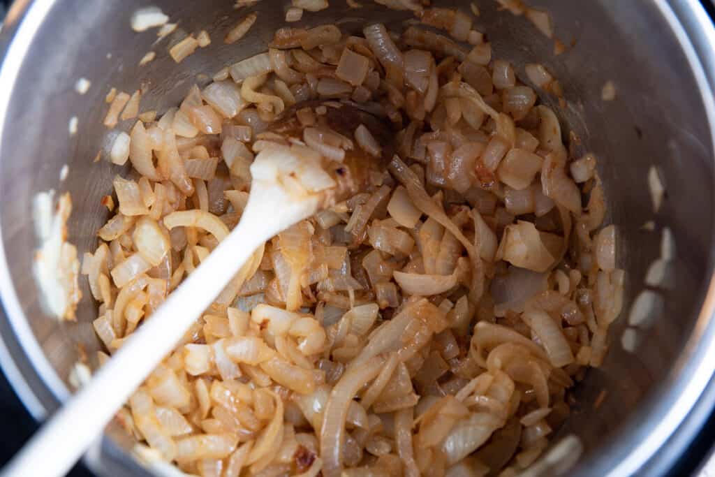 onions browning with wooden spoon