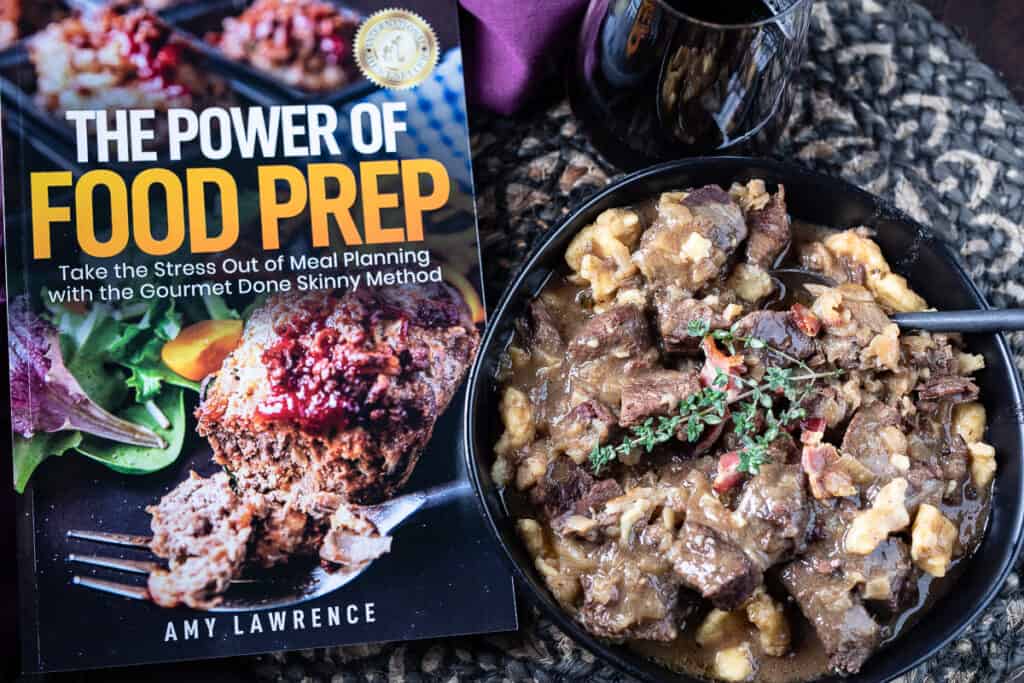 Instant Pot Beef Carbonnade in a black bowl with book